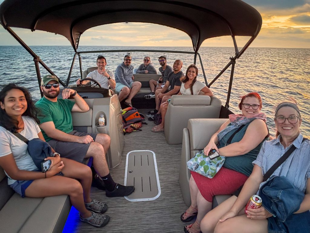 Tora staff on a boat at sunset during one of the company's Lake Days.