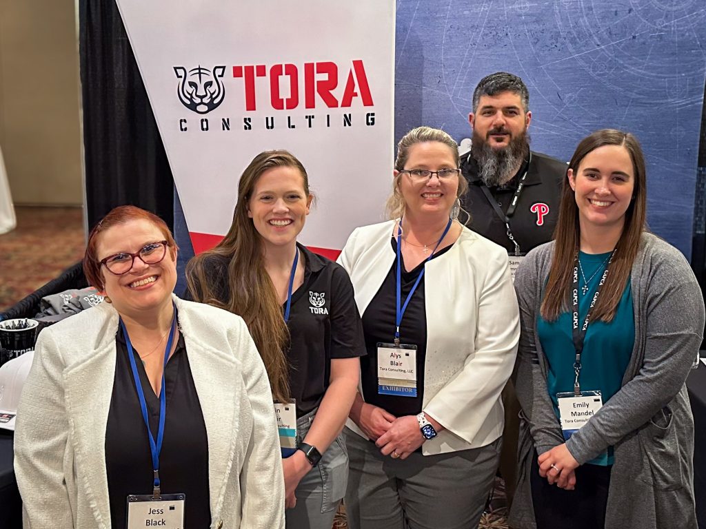 Tora Consulting staff at an environmental compliance professional expo.
