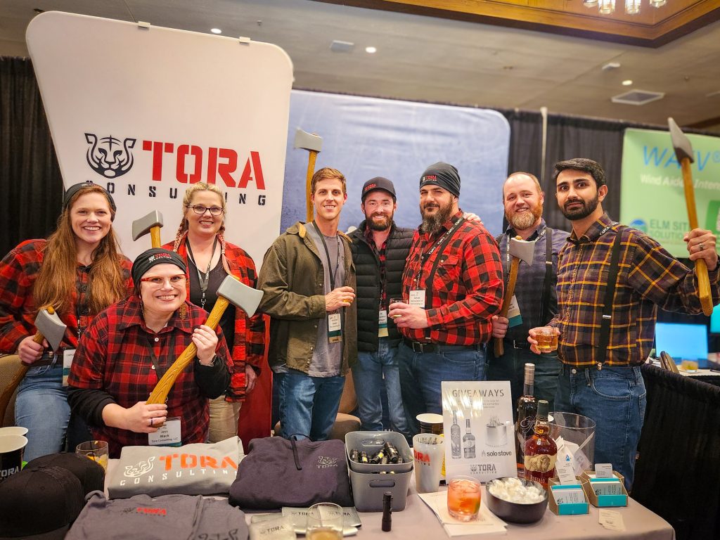 Tora staff dressed up as lumberjacks at a professional expo event.